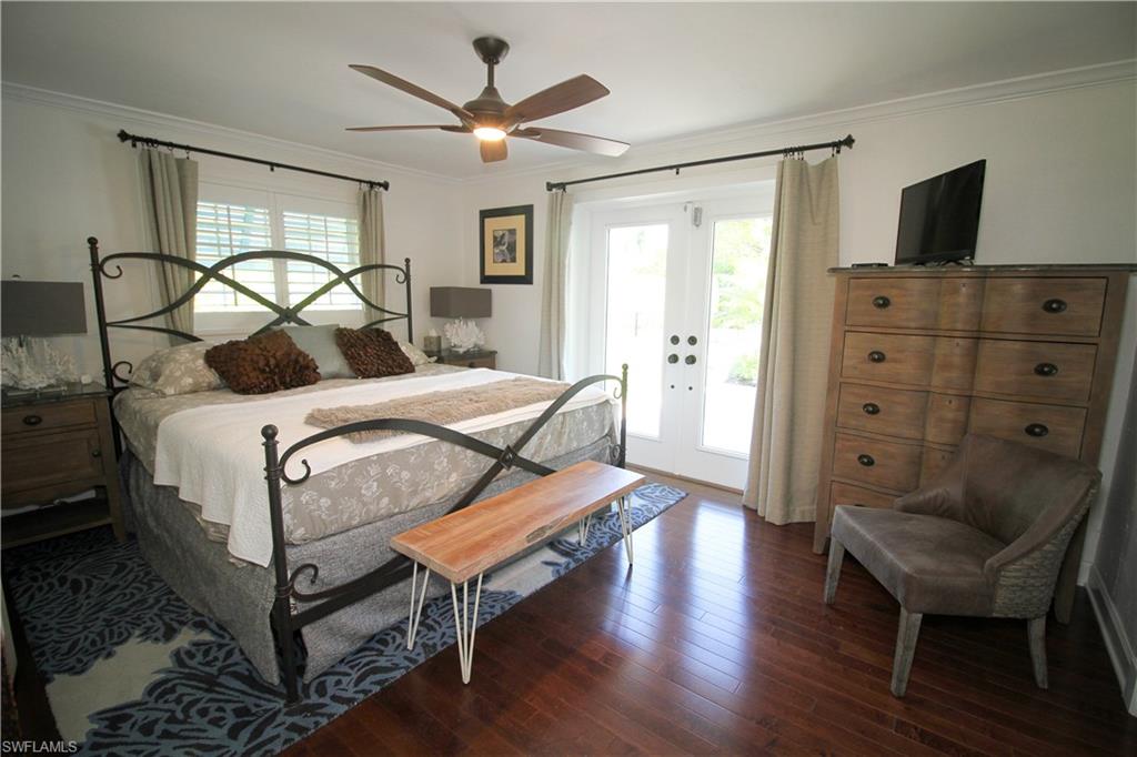 1645 Mullet Court Naples, FL 34102 - Photo 30 of 38 a bedroom with a bed and a television