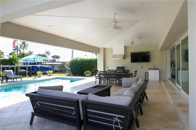 a view of a patio with table and chairs potted plants with wooden floor and plants