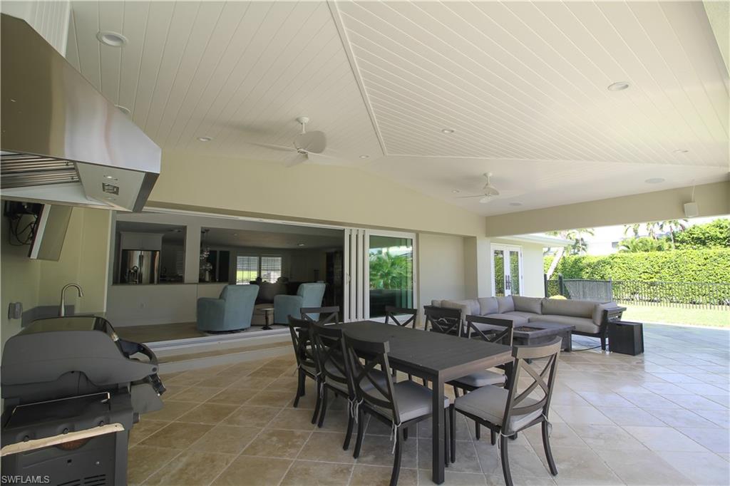 1645 Mullet Court Naples, FL 34102 - Photo 10 of 38 a view of a dining room with furniture window and outside view
