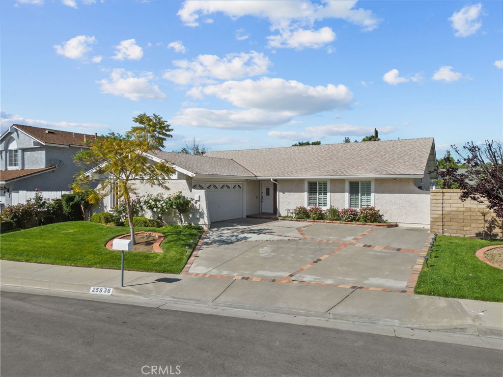 25536 Old Course Way Valencia, CA 91355 - Photo 2 of 37 a front view of a house with a yard and potted plants