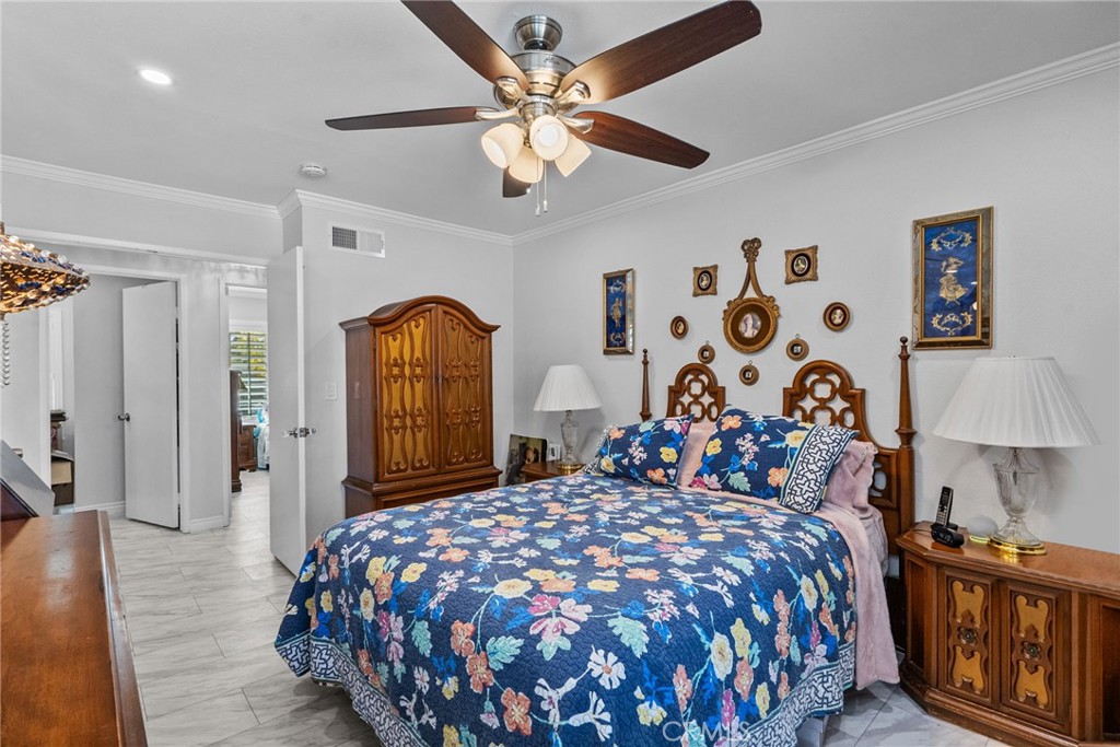 25536 Old Course Way Valencia, CA 91355 - Photo 23 of 37 a bedroom with bed and a chandelier