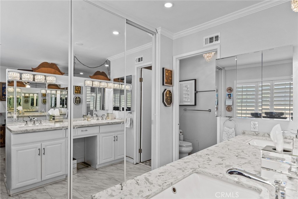 25536 Old Course Way Valencia, CA 91355 - Photo 26 of 37 a kitchen with stainless steel appliances kitchen island granite countertop a refrigerator and a sink
