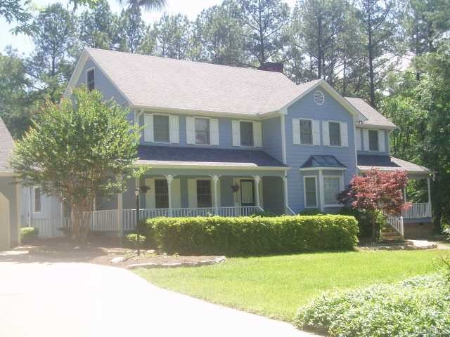 5104 Hallmark Road Durham, NC 27712 - Photo 1 of 12 a front view of a house with a yard and garage