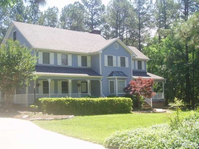 5104 Hallmark Road Durham, NC 27712 - Photo 2 of 12 a front view of a house with a yard and garage