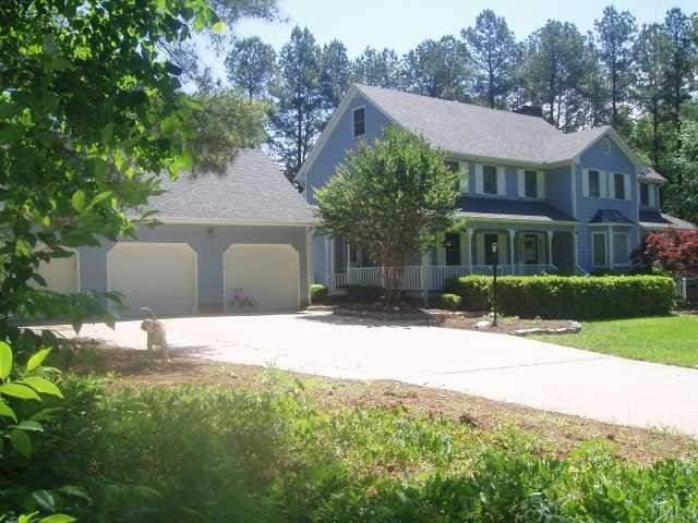 5104 Hallmark Road Durham, NC 27712 - Photo 4 of 12 a house with trees in the background