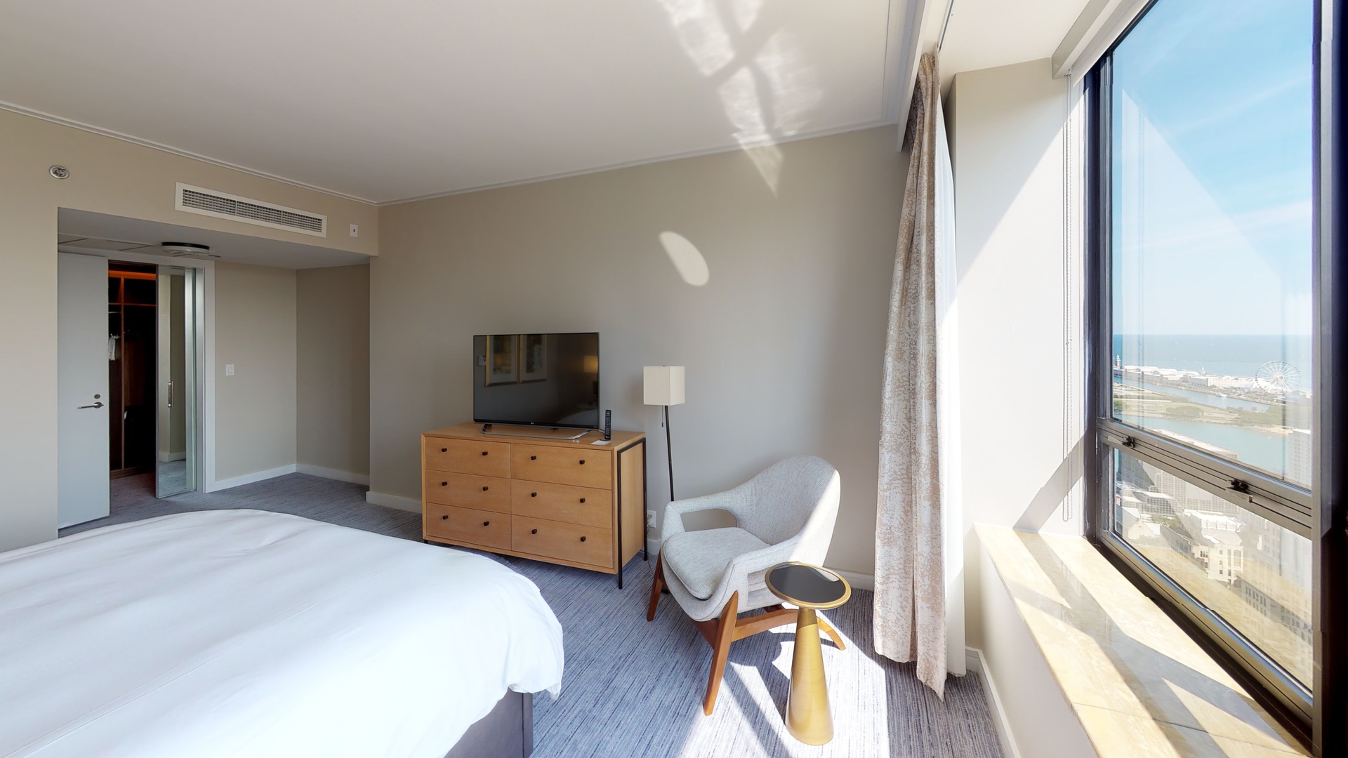 160 East Pearson Street, Unit 3104 Chicago, IL 60611 - Photo 2 of 12 a bedroom with a bed and a flat screen tv