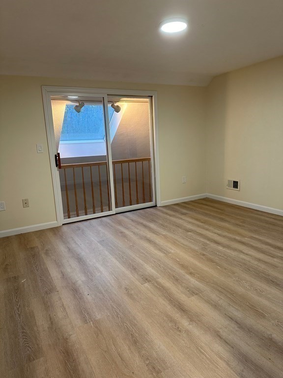 9 Averill Road, Unit B Middleton, MA 01949 - Photo 16 of 18 a view of empty room with wooden floor