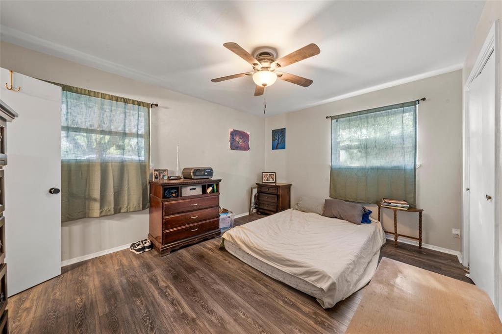 5907 Caldwell Street Waco, TX 76710 - Photo 14 of 22 a bedroom with a bed and wooden floor