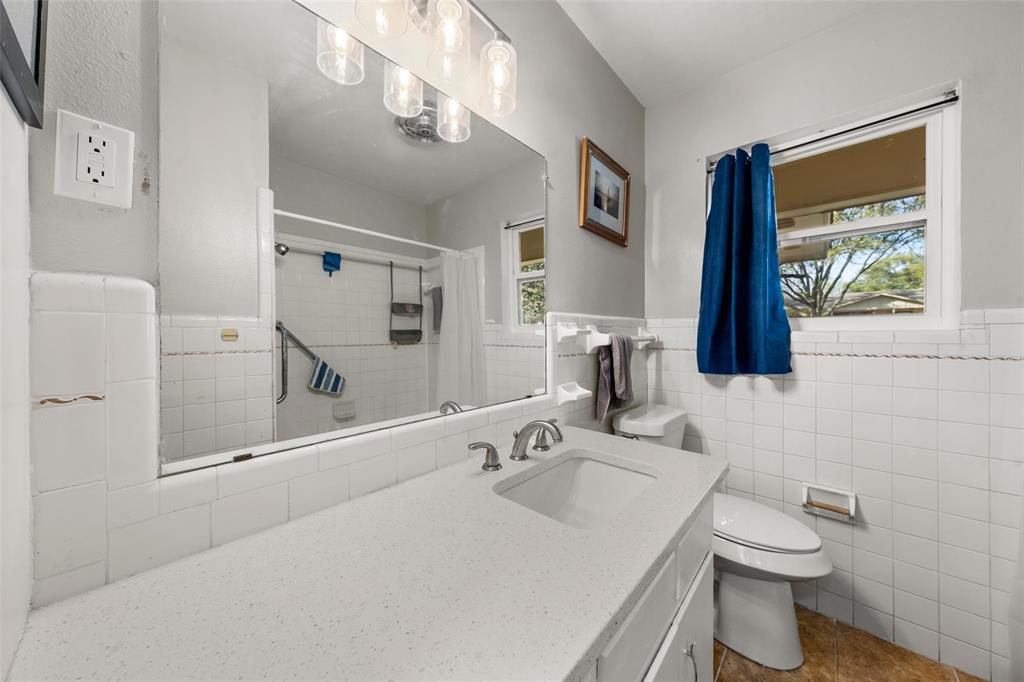5907 Caldwell Street Waco, TX 76710 - Photo 15 of 22 a bathroom with a sink a toilet and a mirror