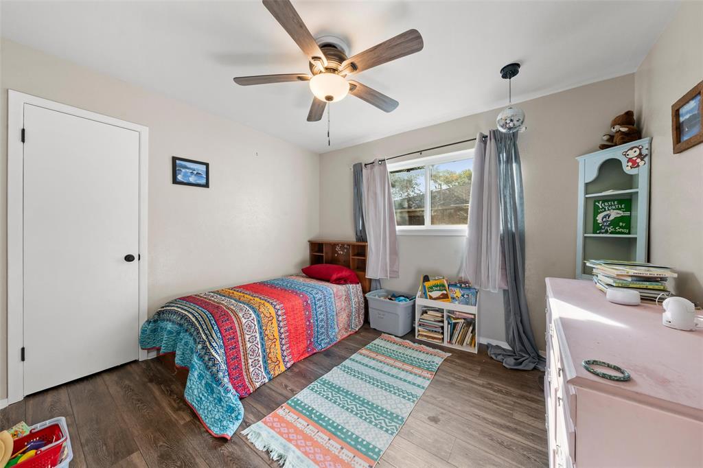 5907 Caldwell Street Waco, TX 76710 - Photo 18 of 22 a bedroom with a bed and wooden floor