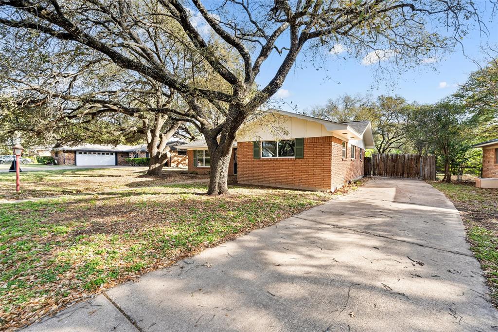 5907 Caldwell Street Waco, TX 76710 - Photo 20 of 22 a view of a yard with a house and a large tree