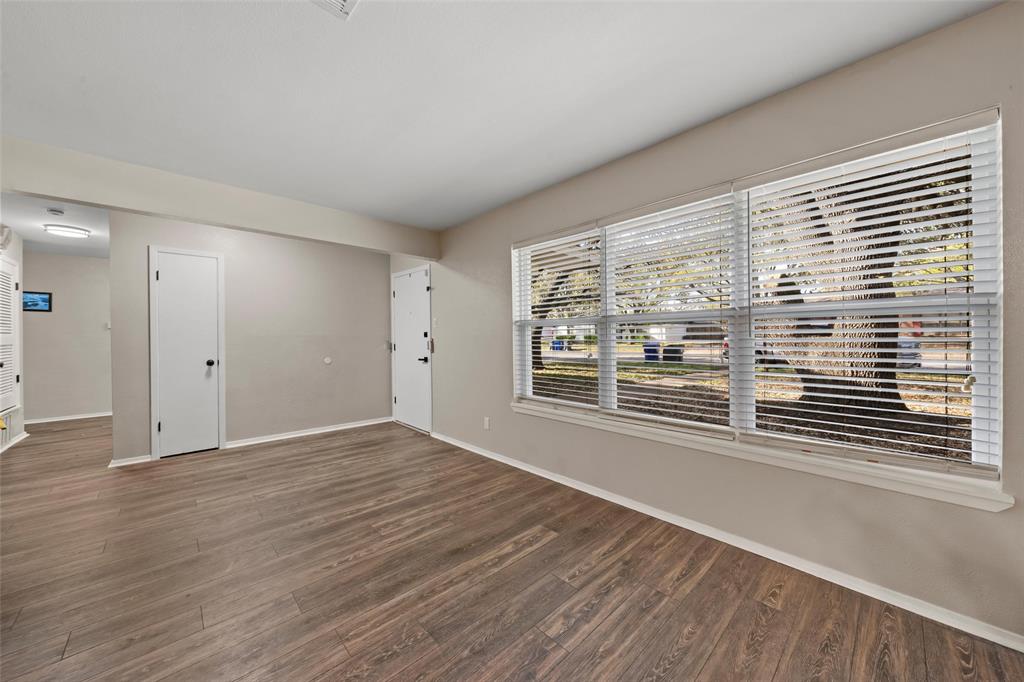 5907 Caldwell Street Waco, TX 76710 - Photo 3 of 22 a view of an empty room with wooden floor and a window