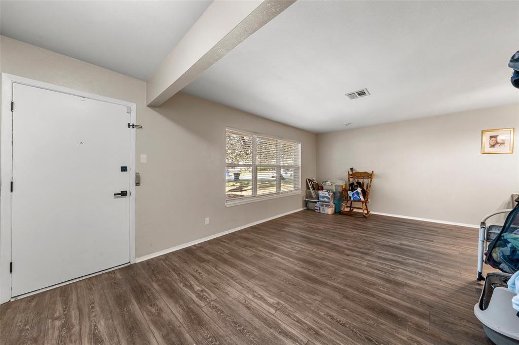 5907 Caldwell Street Waco, TX 76710 - Photo 5 of 22 wooden floor in an empty room with a window