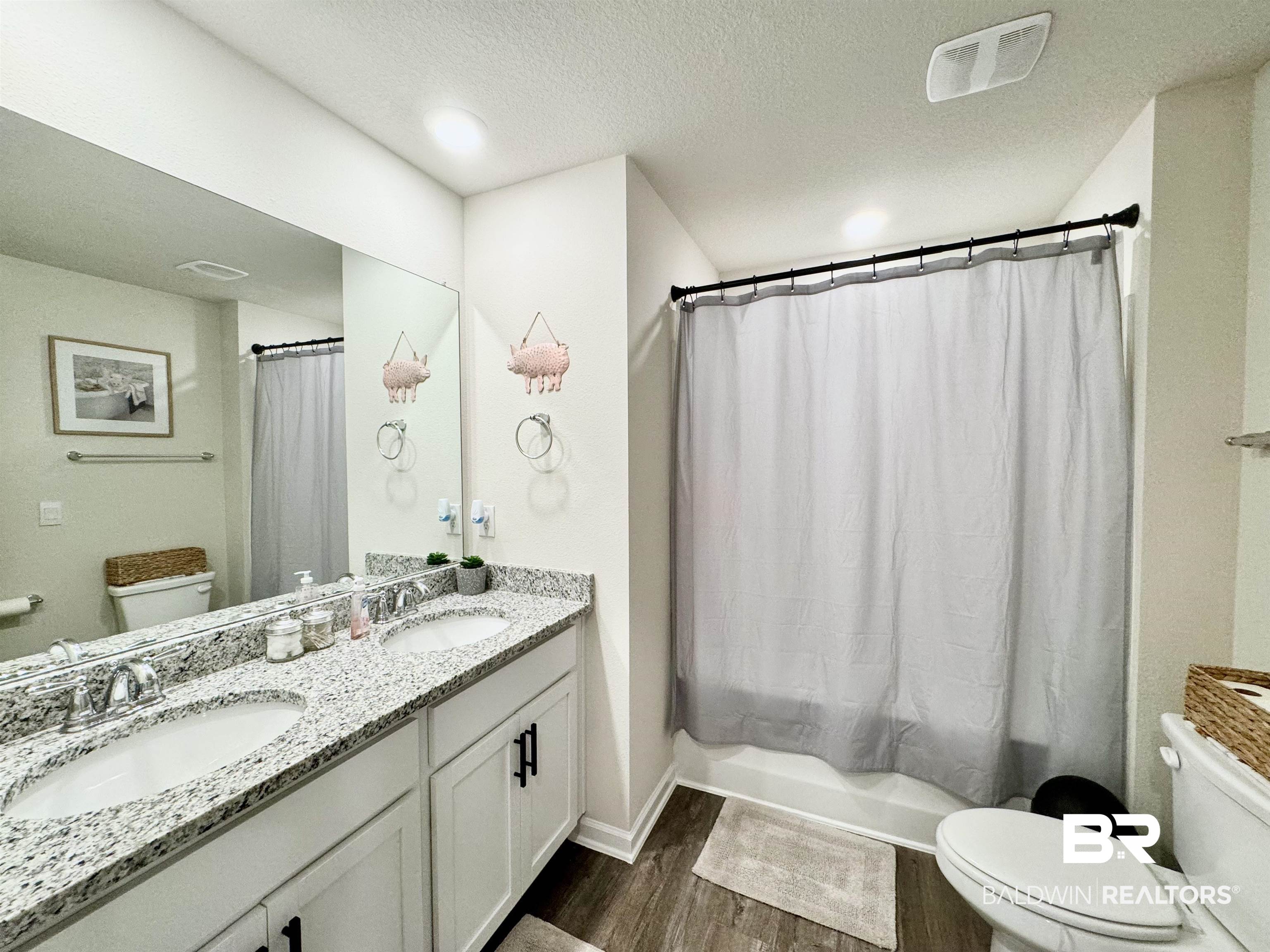 24216 Ringneck Loop Elberta, AL 36530 - Photo 15 of 23 Full bath with shower / bath combination with curtain, a textured ceiling, dark wood-style flooring, and double vanity