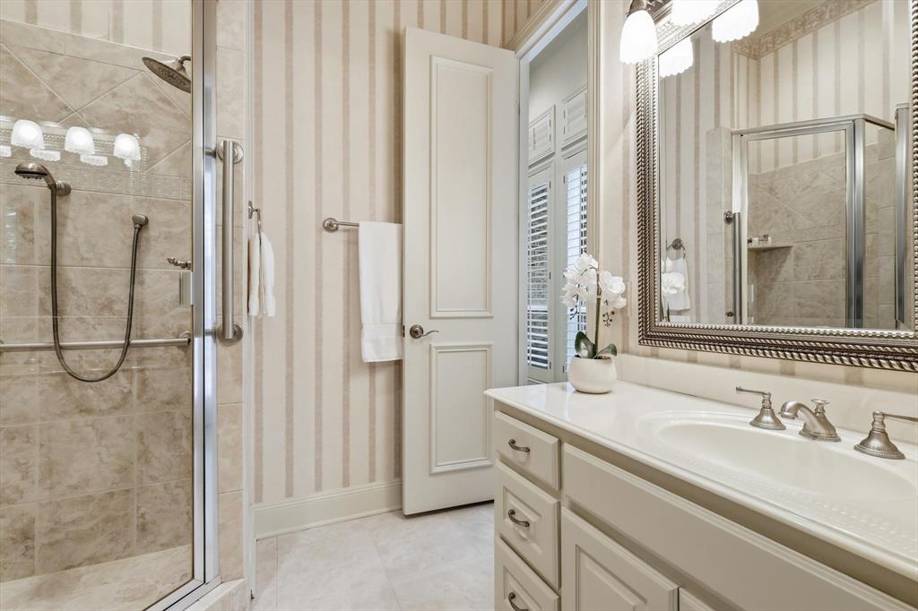 970 Crystal Cove Oak Point, TX 75068 - Photo 27 of 40 a bathroom with a granite countertop sink and a mirror
