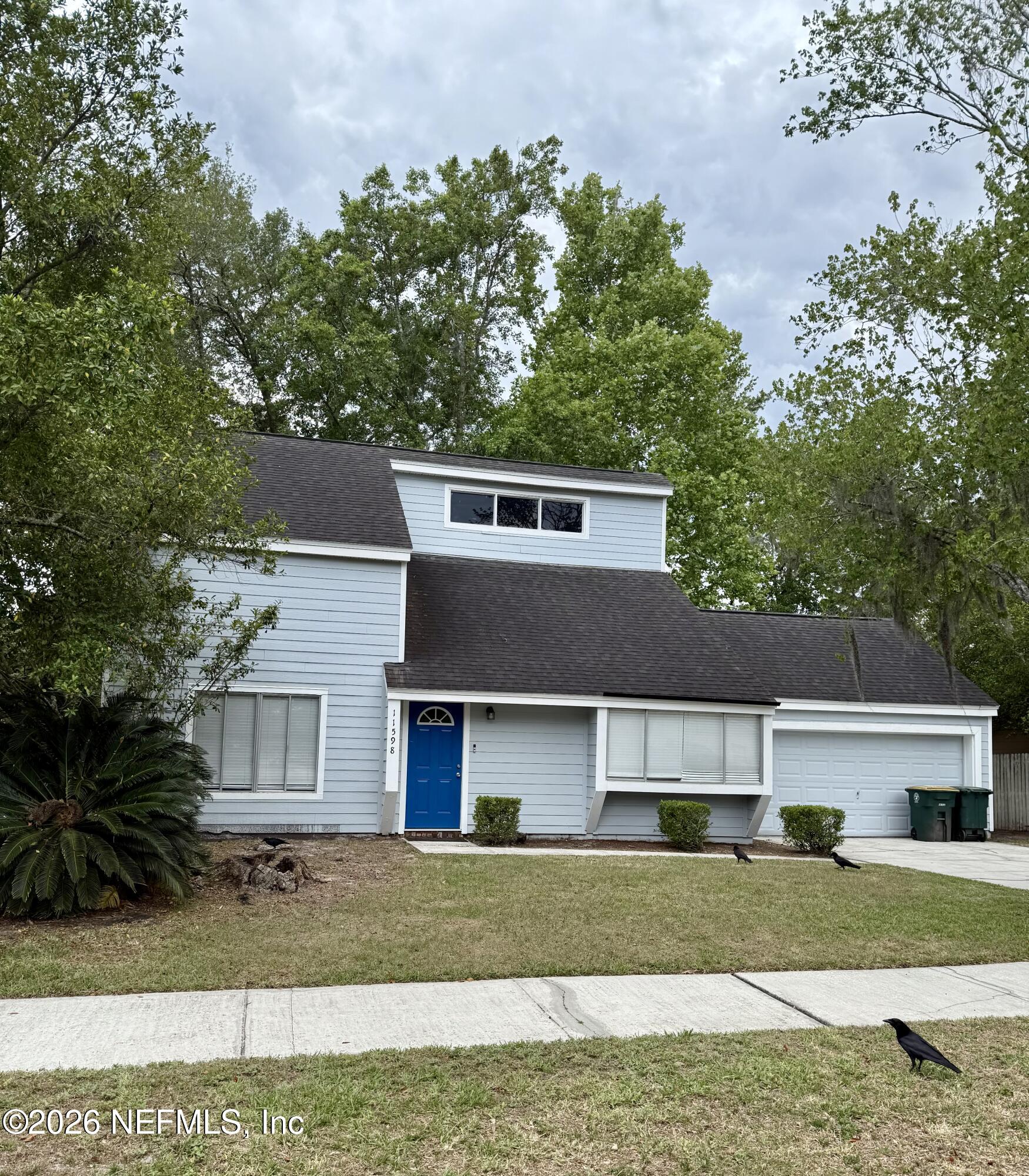 11598 West Ride Drive Jacksonville, FL 32223 - Photo 1 of 15 a front view of a house with a yard