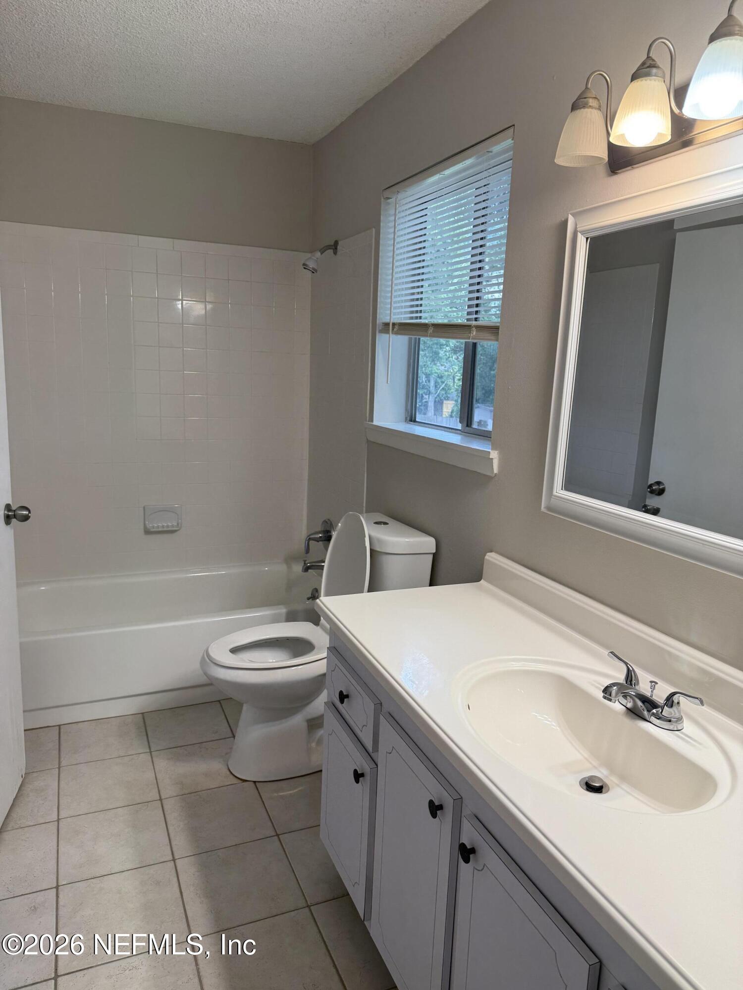 11598 West Ride Drive Jacksonville, FL 32223 - Photo 11 of 15 a bathroom with a sink a toilet and shower