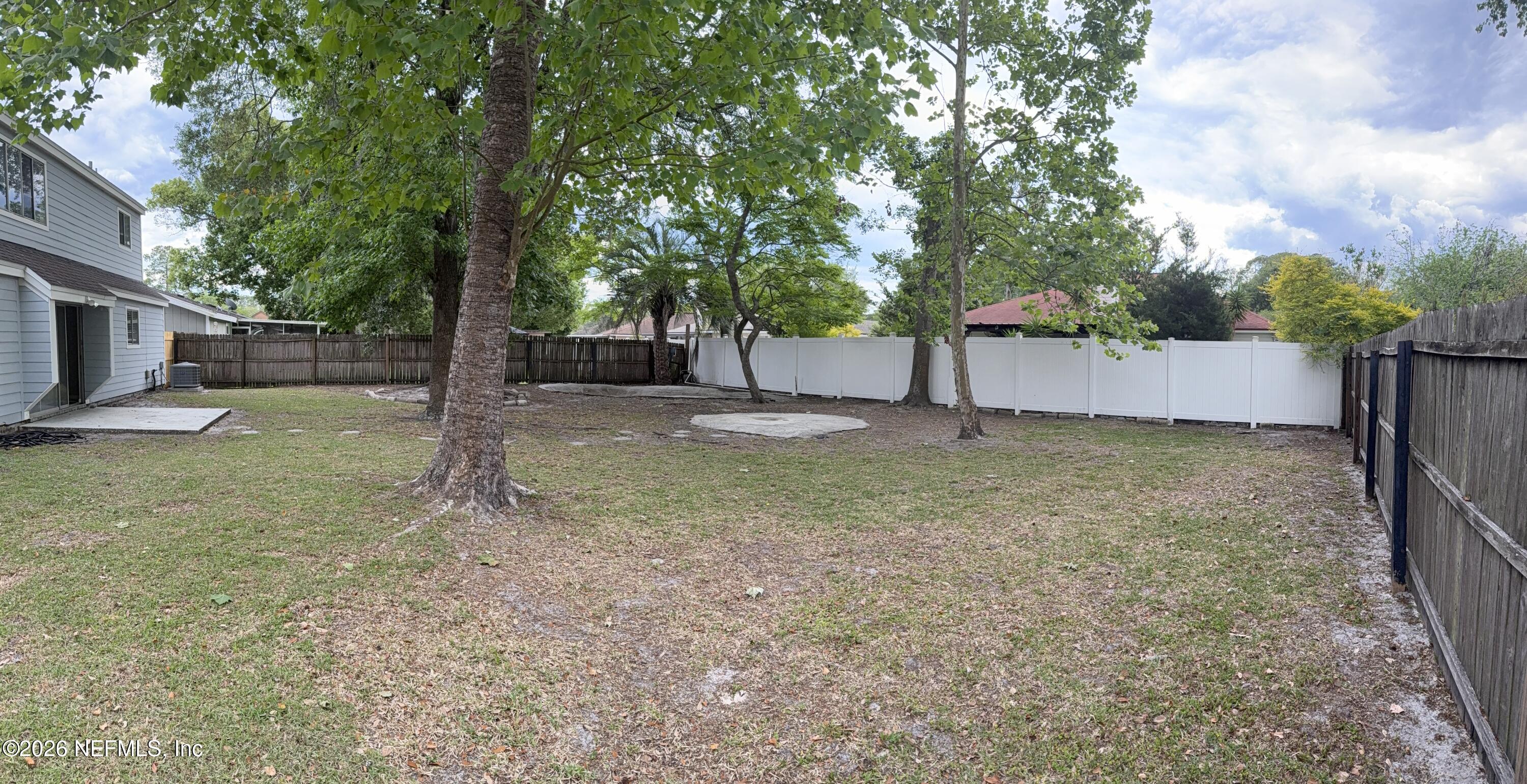 11598 West Ride Drive Jacksonville, FL 32223 - Photo 14 of 15 a backyard of a house with lots of green space