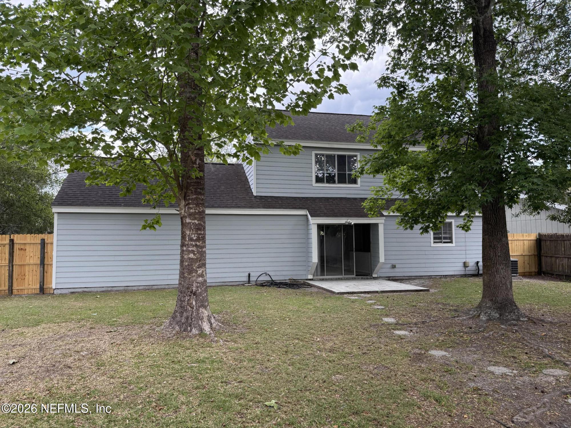 11598 West Ride Drive Jacksonville, FL 32223 - Photo 15 of 15 a front view of a house with yard and garage
