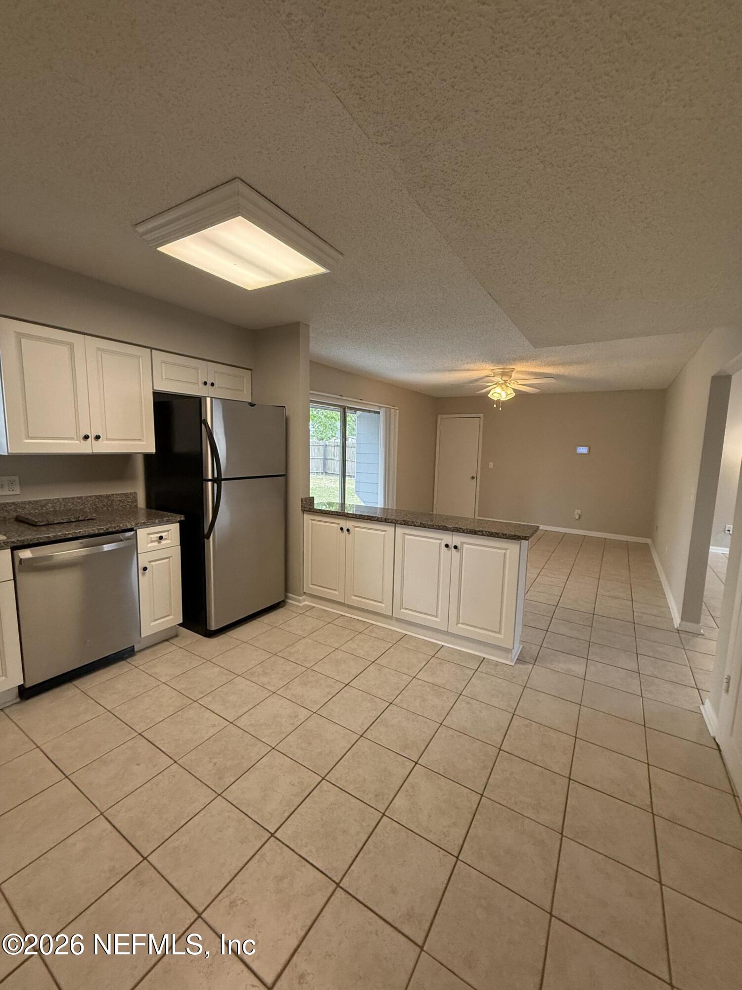 11598 West Ride Drive Jacksonville, FL 32223 - Photo 7 of 15 a view of a kitchen with microwave and cabinets