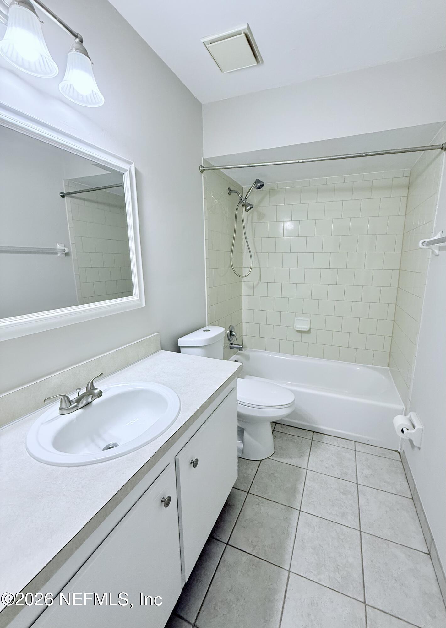 11598 West Ride Drive Jacksonville, FL 32223 - Photo 10 of 15 a bathroom with a granite countertop sink a toilet and bathtub