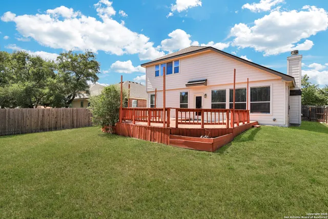 a view of a house with a yard patio and a slide