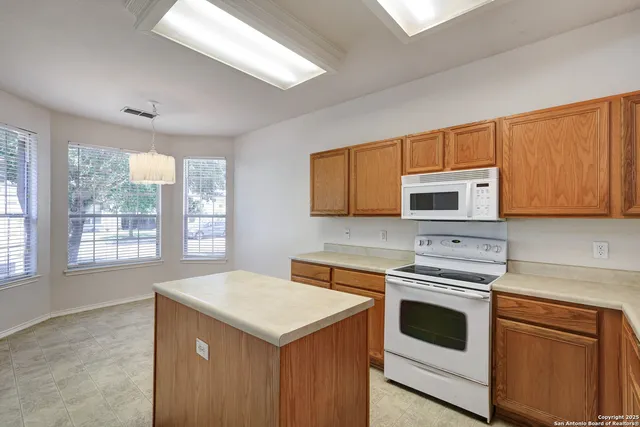 a kitchen with stainless steel appliances a stove a sink and a microwave