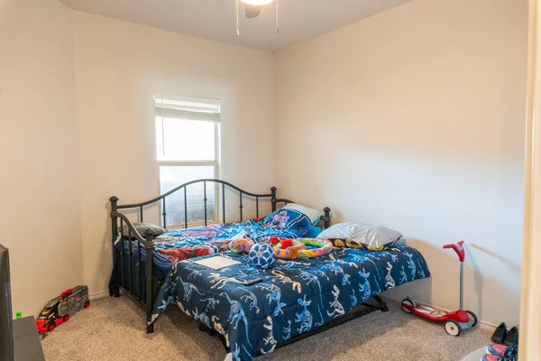 a bedroom with bed and a window