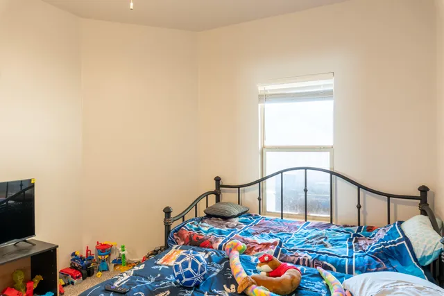 a bedroom with bed and a window