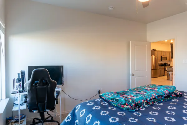 a bedroom with a bed and a chandelier