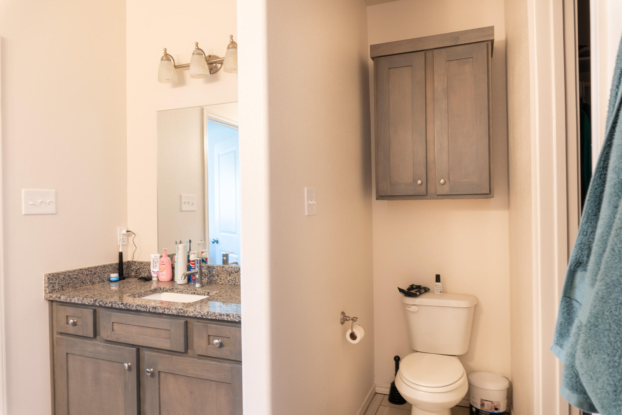 2625 136th Street Lubbock, TX 79423 - Photo 24 of 29 a bathroom with a granite countertop sink toilet and mirror