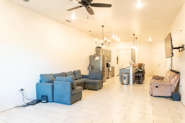 a living room with furniture and a chandelier