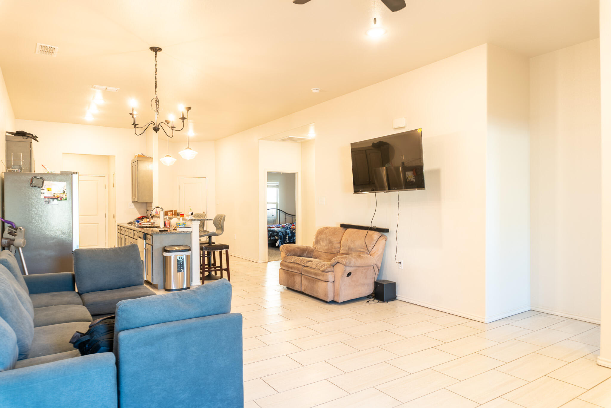 2625 136th Street Lubbock, TX 79423 - Photo 9 of 29 a living room with furniture and a flat screen tv