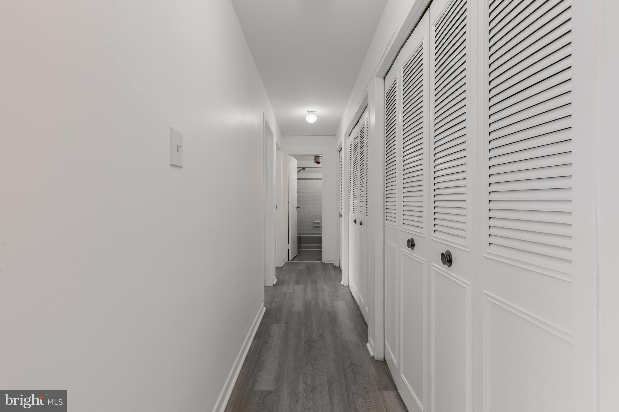 10201 Grosvenor Place, Unit 204 Rockville, MD 20852 - Photo 11 of 25 a view of a hallway with wooden floor