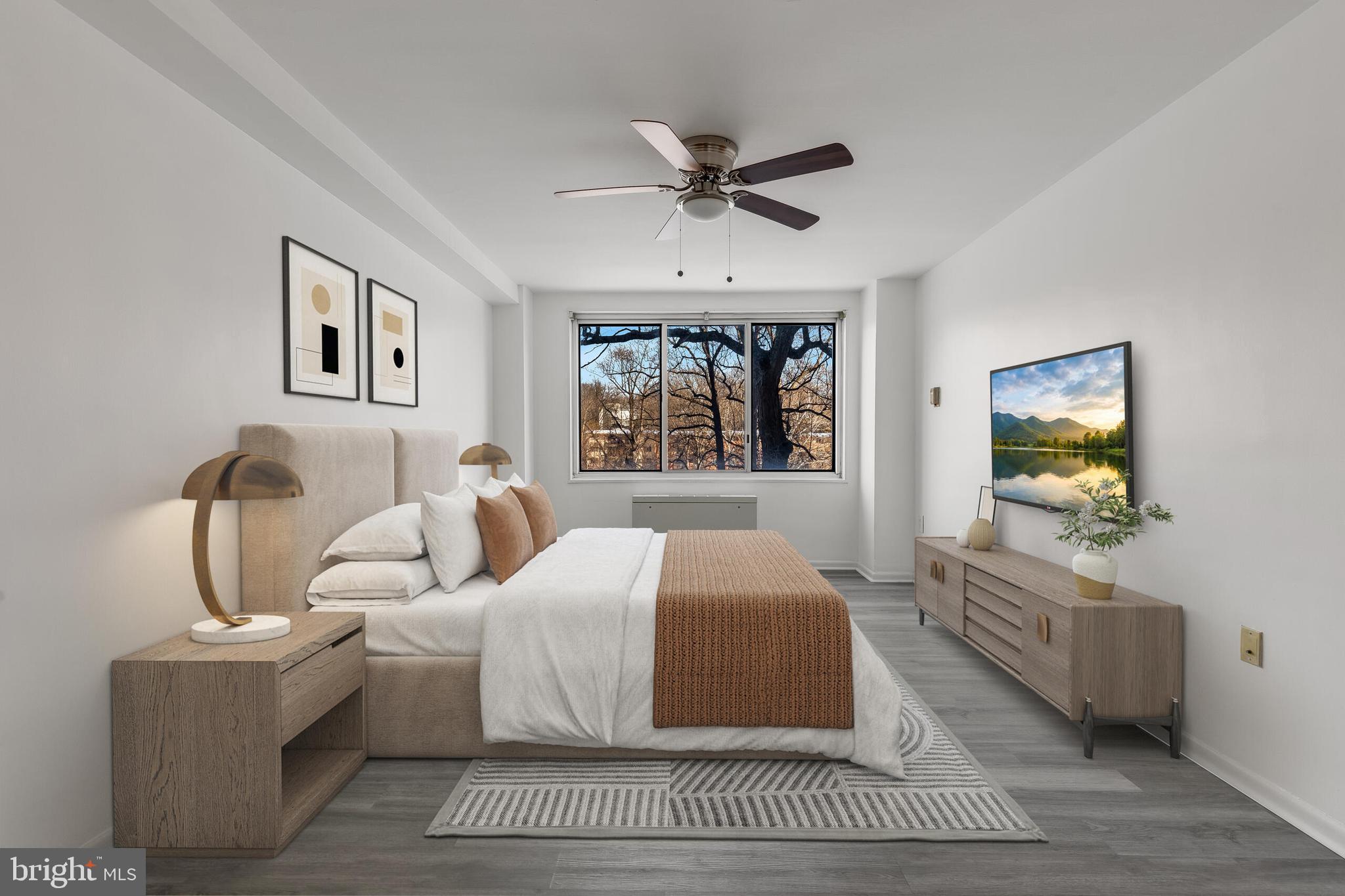 10201 Grosvenor Place, Unit 204 Rockville, MD 20852 - Photo 13 of 25 a bedroom with a bed and a flat screen tv