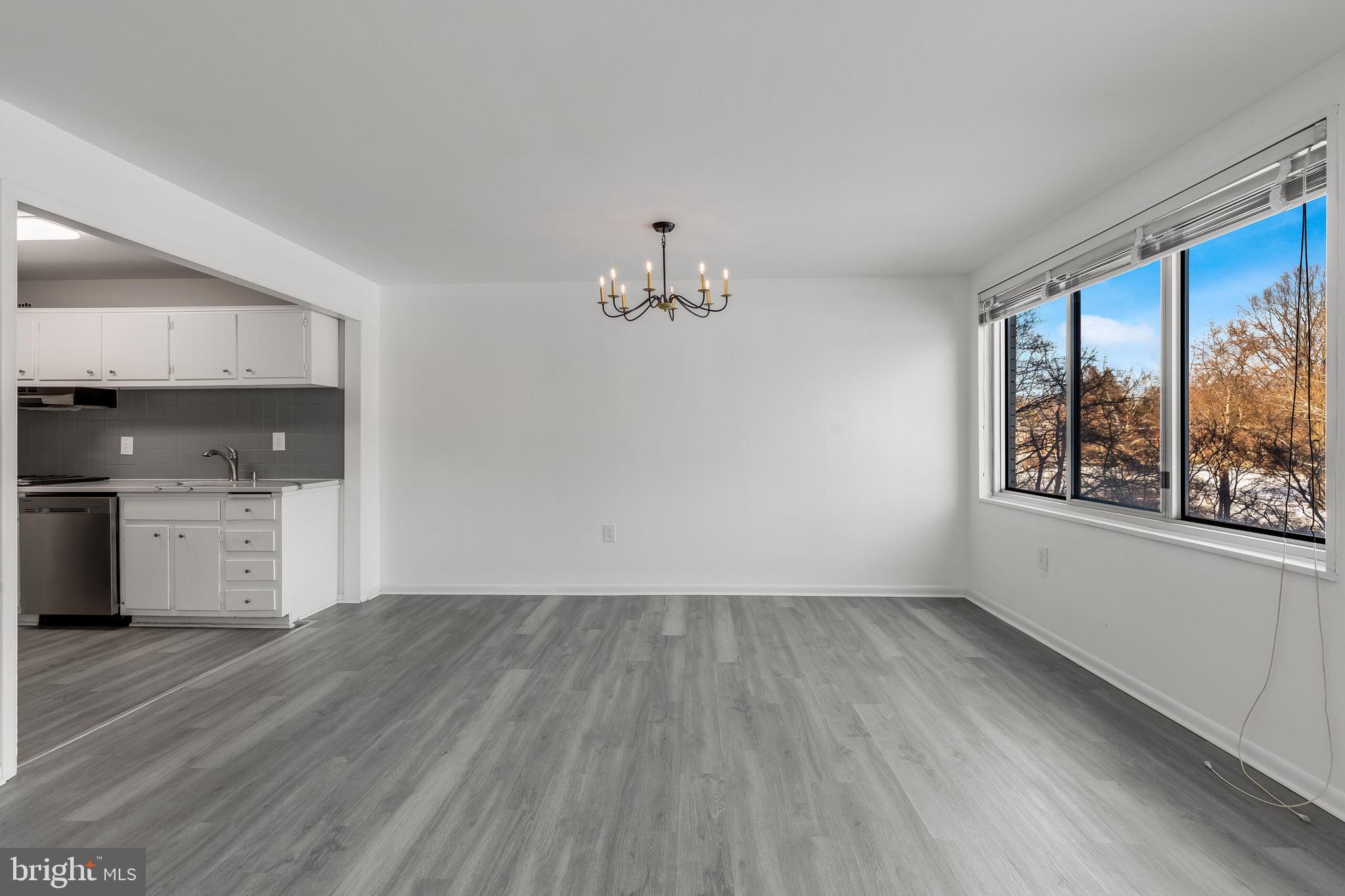 10201 Grosvenor Place, Unit 204 Rockville, MD 20852 - Photo 8 of 25 wooden floor in an empty room with a window