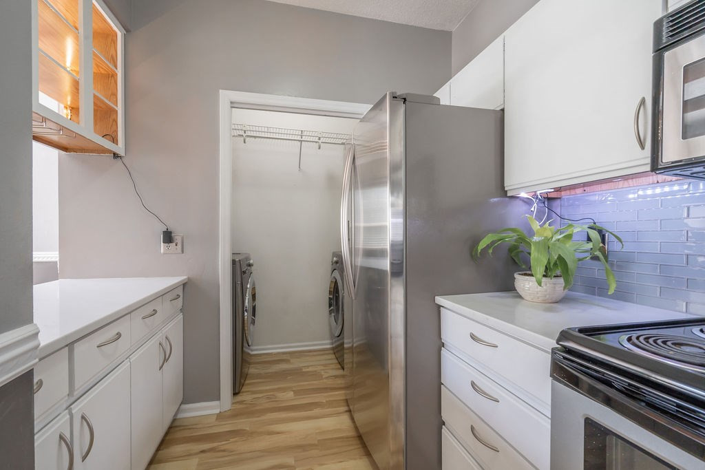 6020 Winterpointe Lane, Unit 201 Raleigh, NC 27606 - Photo 5 of 17 Laundry is located by kitchen in a nice little nook with storage. Laundry