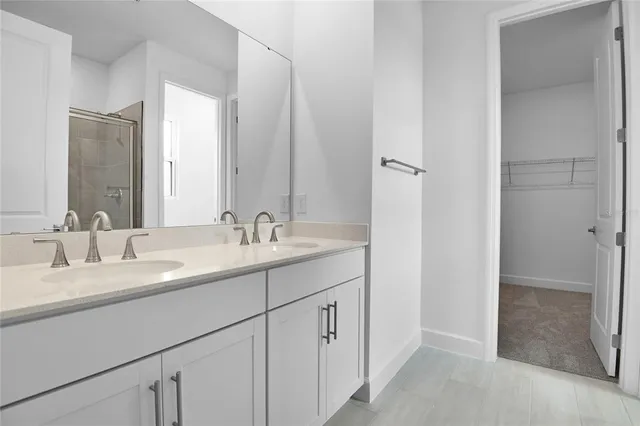 a bathroom with a double vanity sink and mirror