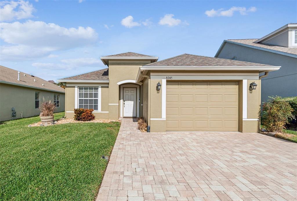 8245 Crescent Moon Drive New Port Richey, FL 34655 - Photo 1 of 1 a front view of a house with a yard and garage