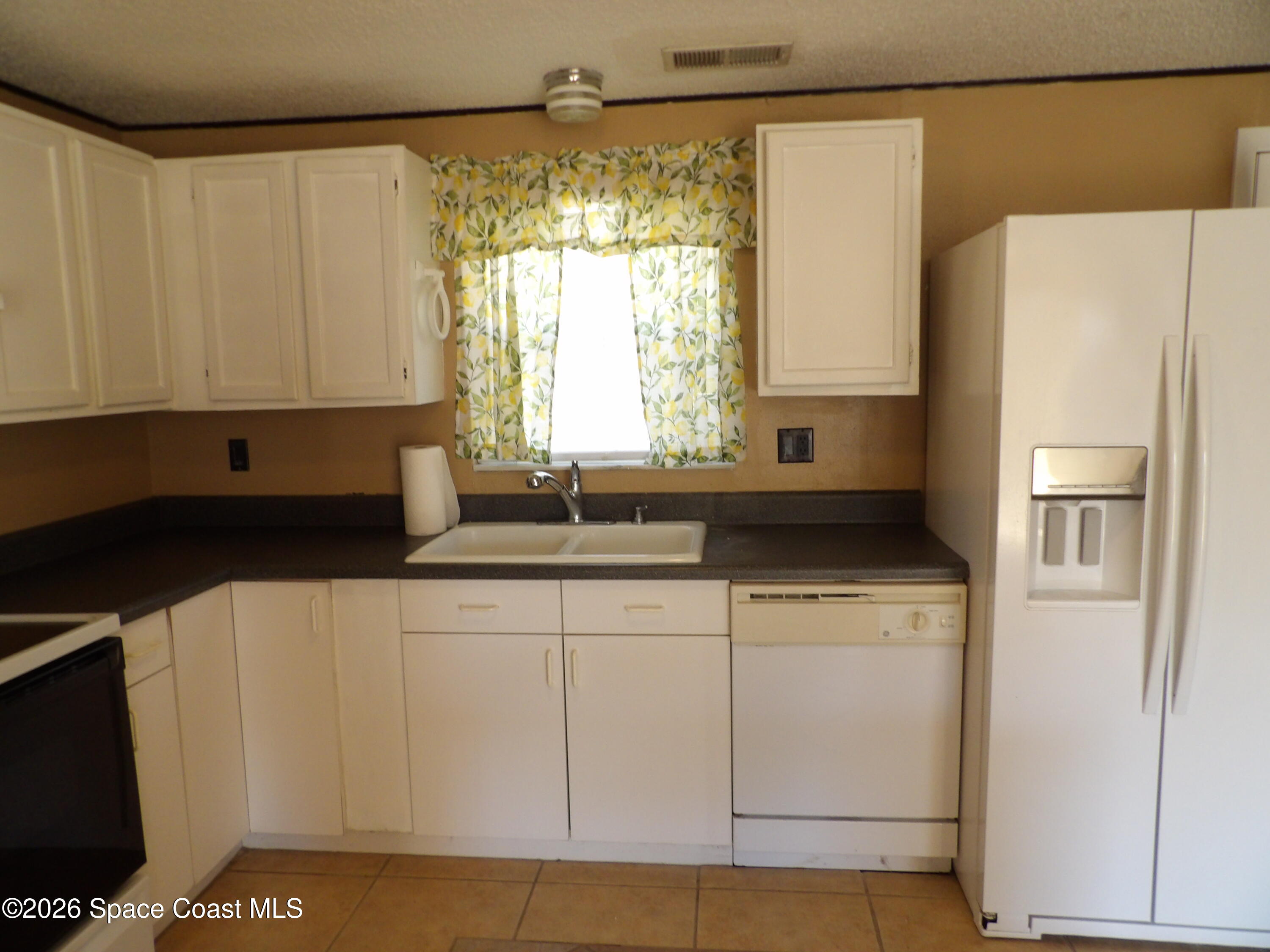 6318 Hudson Road Cocoa, FL 32927 - Photo 11 of 38 a kitchen with appliances cabinets and a sink
