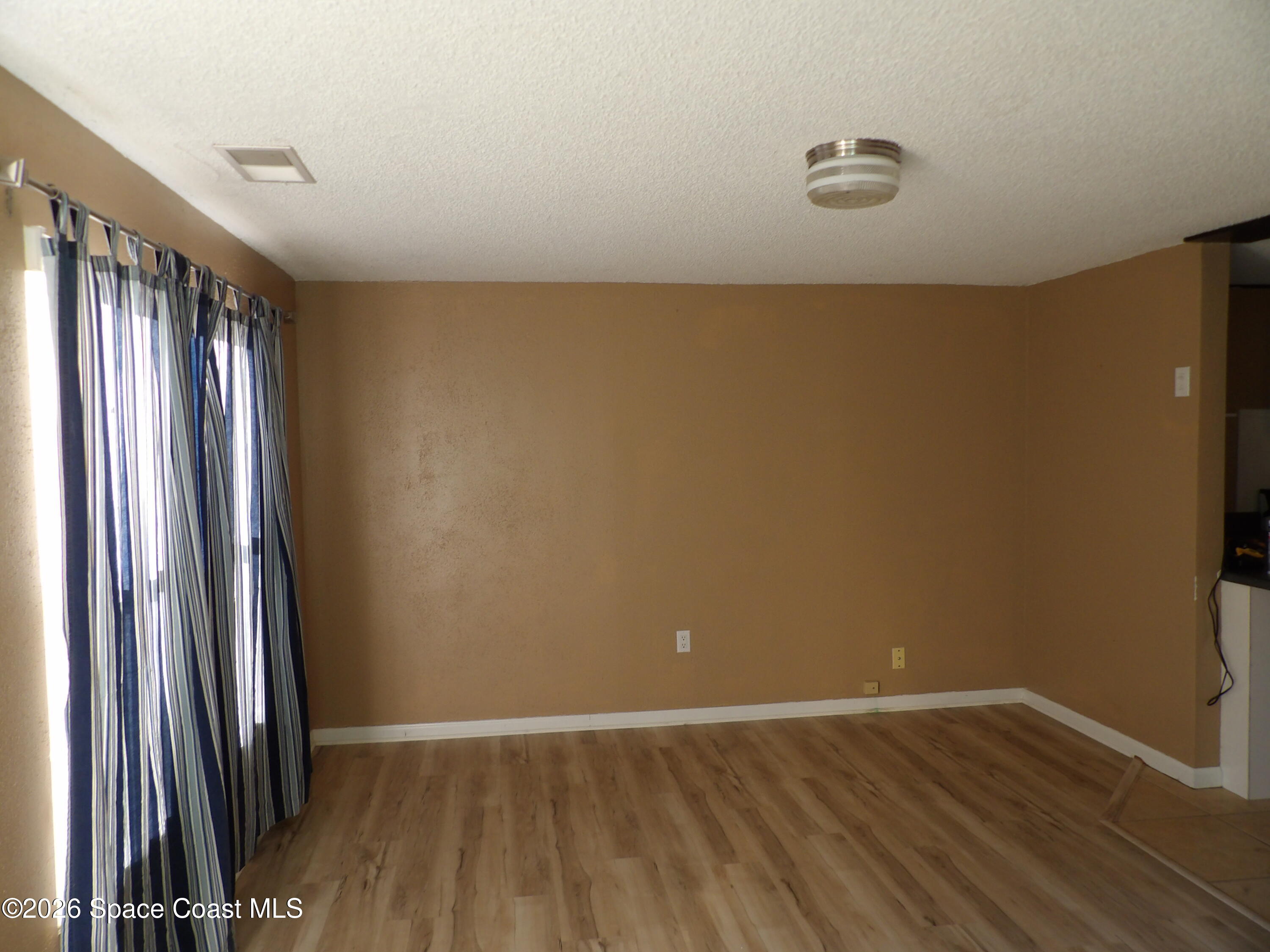 6318 Hudson Road Cocoa, FL 32927 - Photo 15 of 38 an empty room with wooden floor and entrance