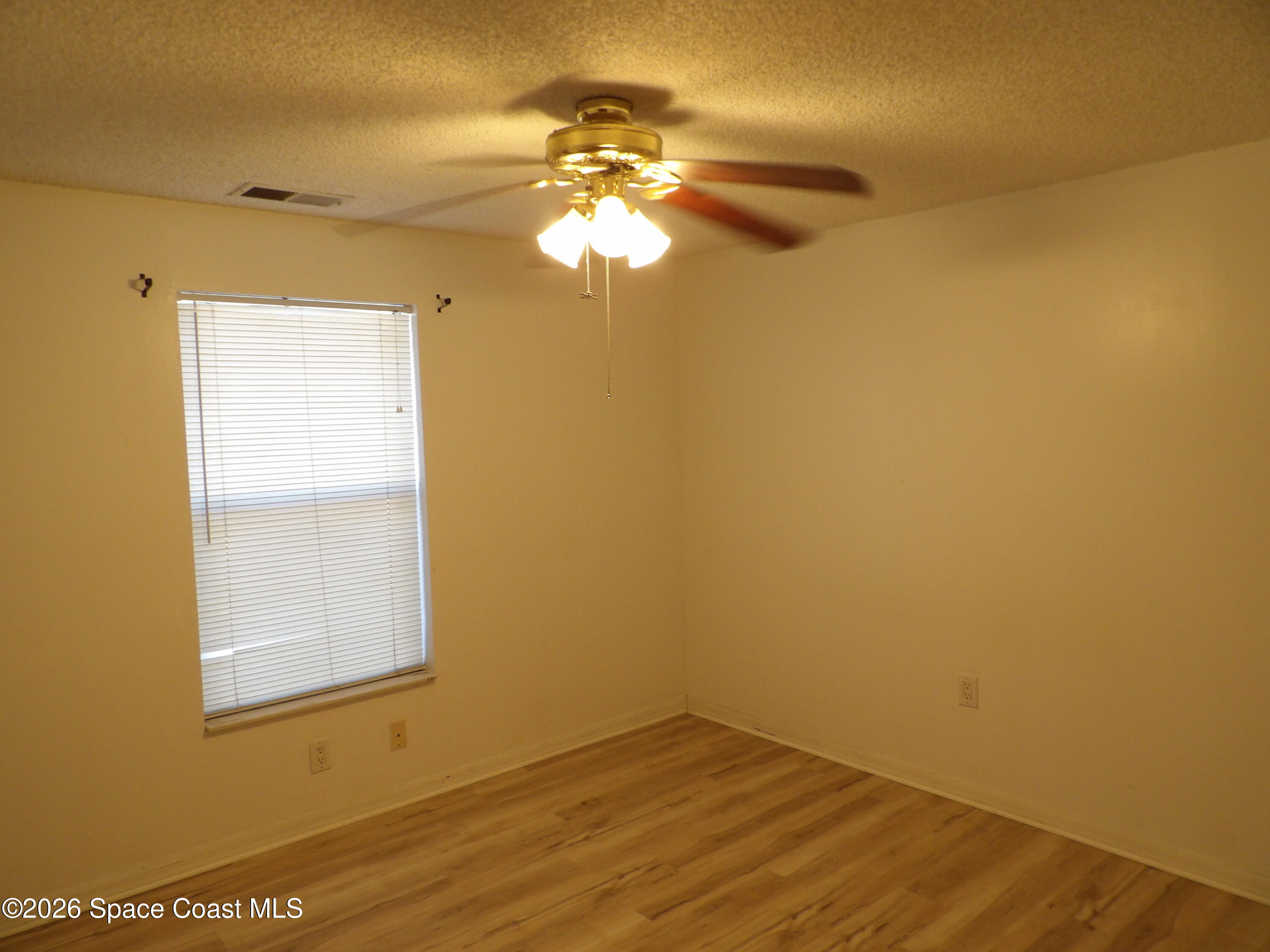 6318 Hudson Road Cocoa, FL 32927 - Photo 28 of 38 a view of a room with wooden floor and small window