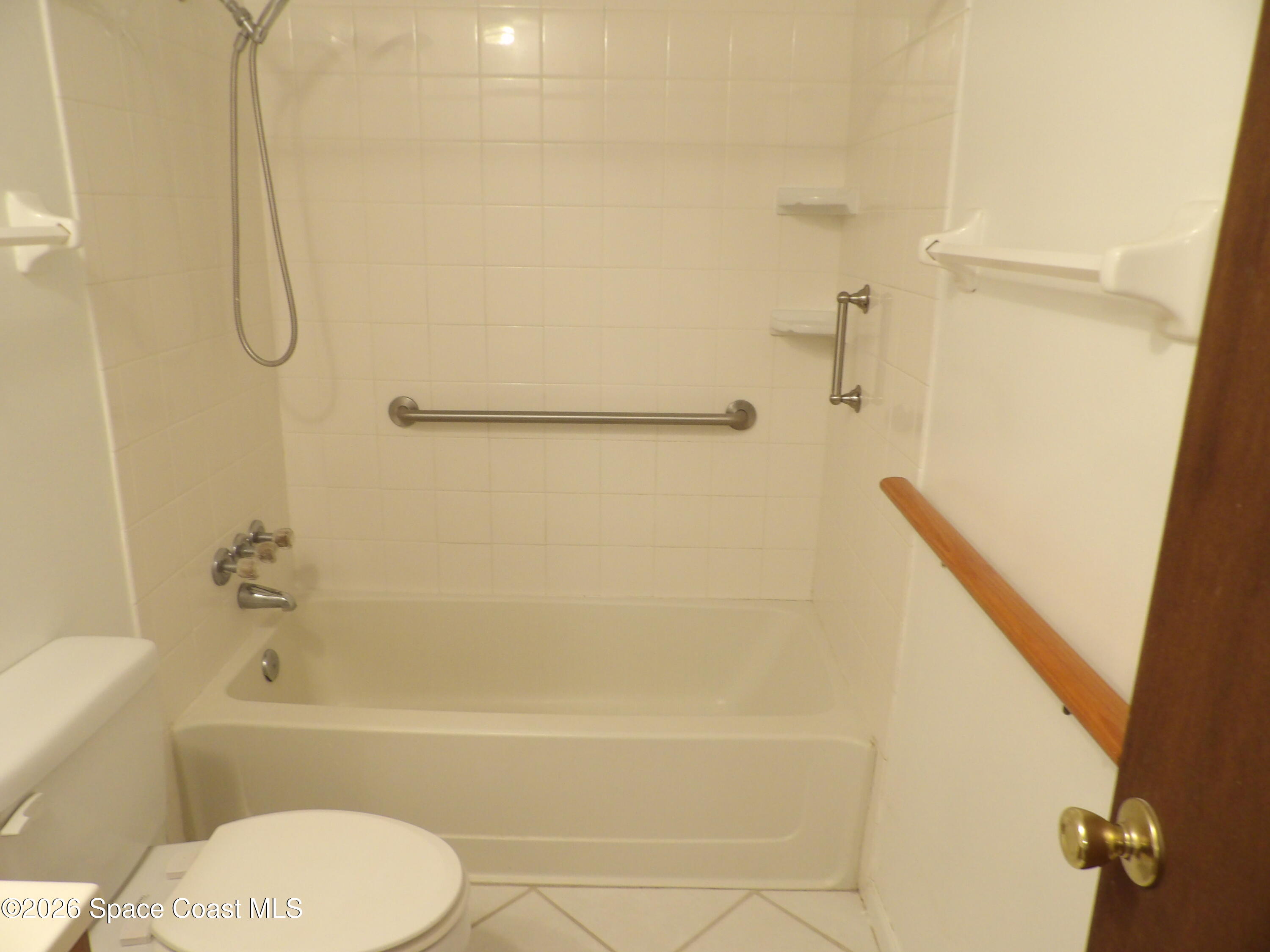 6318 Hudson Road Cocoa, FL 32927 - Photo 32 of 38 a bathroom with a toilet and a bath tub