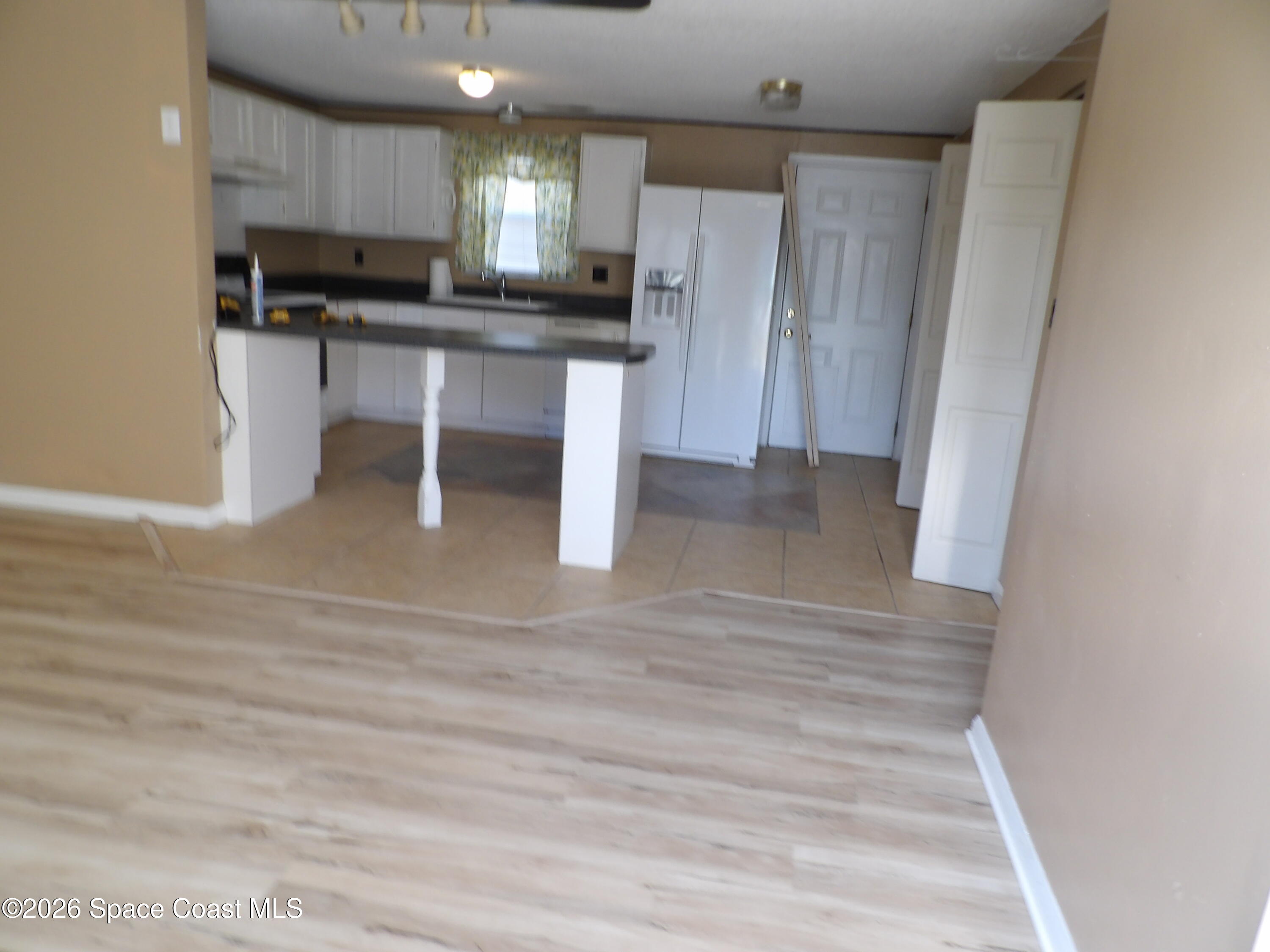 6318 Hudson Road Cocoa, FL 32927 - Photo 7 of 38 a view of kitchen with stainless steel appliances granite countertop cabinets and wooden floor