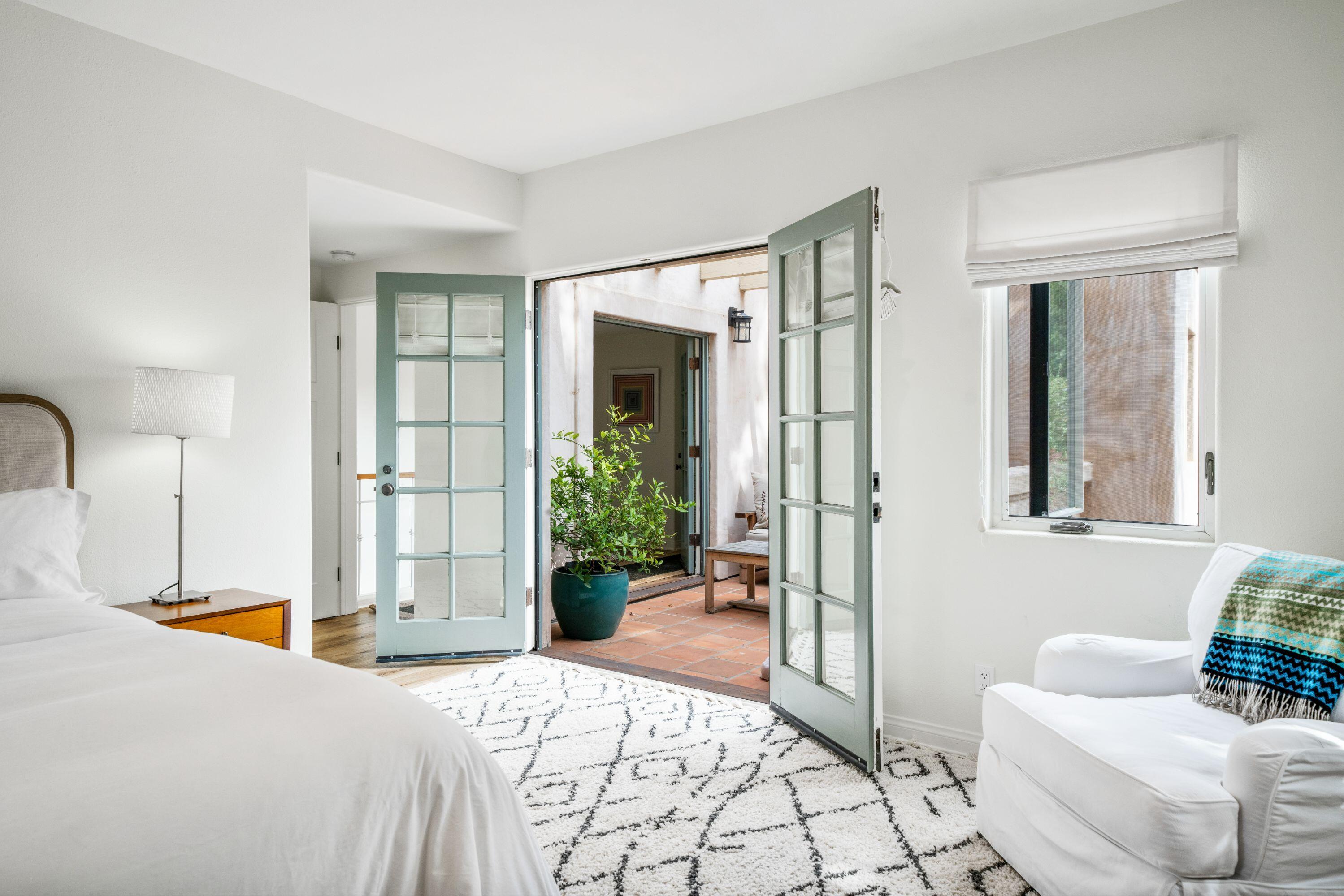 81 Depot Road Santa Barbara, CA 93108 - Photo 14 of 21 a bedroom with a bed couch and windows