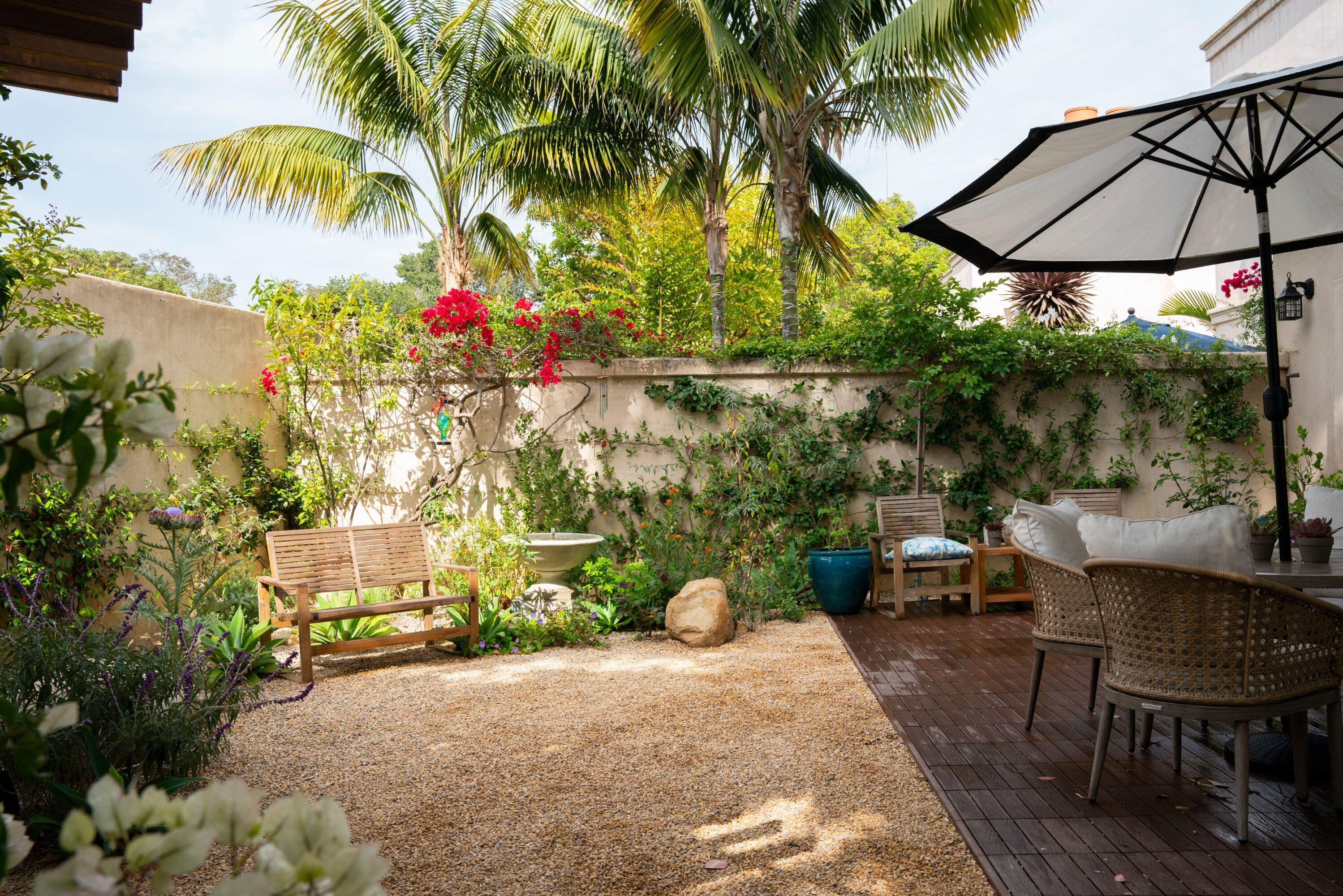 81 Depot Road Santa Barbara, CA 93108 - Photo 7 of 21 a backyard of a house with table and chairs under an umbrella
