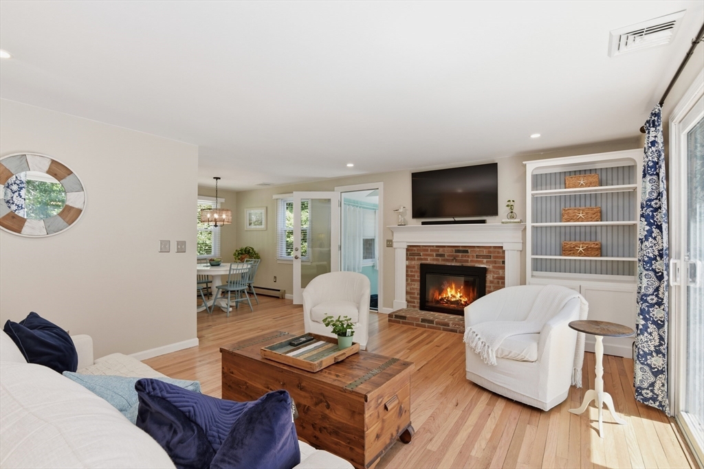 8 Emerald Way Sandwich, MA 02644 - Photo 11 of 36 a living room with furniture a fireplace and a flat screen tv