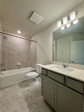 a bathroom with a sink a toilet and bathtub