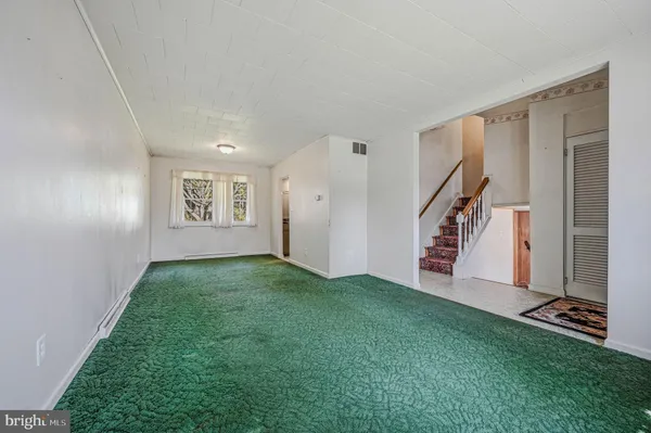 a view of a room with stairs and a wooden floor