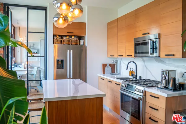 a kitchen with stainless steel appliances a sink stove and refrigerator